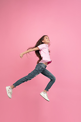 Image showing Caucasian little girl portrait isolated on pink studio background, emotions concept