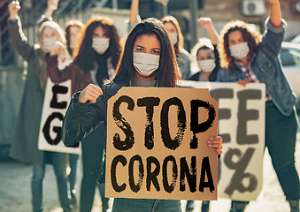 Image showing Young people in face masks protesting of stop coronavirus pandemic on the street