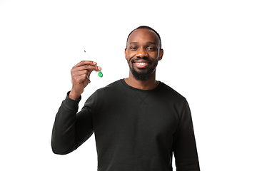 Image showing How coronavirus changed our lives. Young man checking, taking temperature on white background