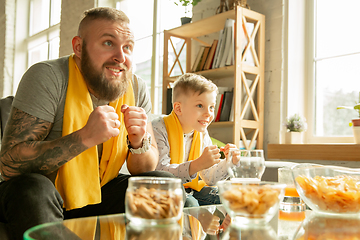 Image showing Excited family watching football, sport match at home, father and son