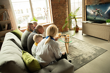 Image showing Excited family watching rugby, sport match at home