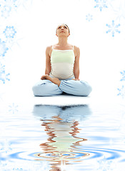 Image showing padmasana lotus pose on white sand