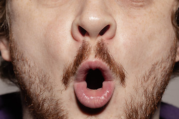 Image showing Close-up male mouth illustrating emotions. Cosmetology, dentistry and beauty care, facial expression