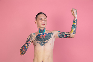 Image showing Portrait of young man with freaky appearance on pink background