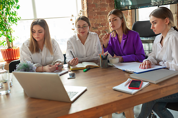 Image showing Business young caucasian woman in modern office with team