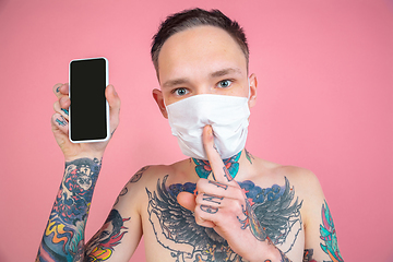 Image showing Portrait of young man with freaky appearance on pink background