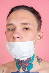 Image showing Portrait of young man with freaky appearance on pink background