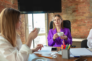 Image showing Business young caucasian woman in modern office with team