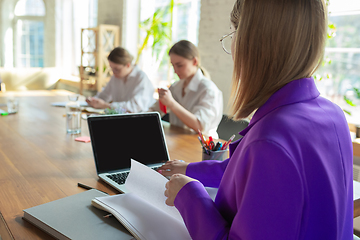 Image showing Business young caucasian woman in modern office with team