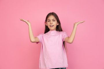 Image showing Caucasian little girl portrait isolated on pink studio background, emotions concept