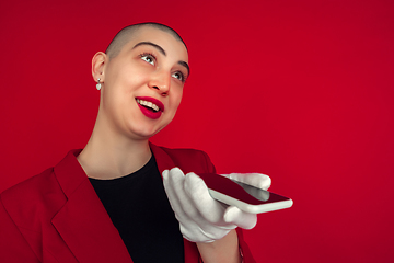 Image showing Portrait of young caucasian bald woman on red background