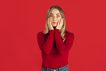 Image showing Monochrome portrait of young caucasian blonde woman on red background