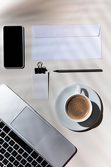 Image showing Creative and cozy workplace at home office, inspirational mock up with plant shadows on table surface