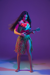 Image showing Fabulous Cinco de Mayo female dancer on purple studio background in neon light