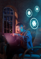 Image showing Shocked, upset and sad man using gadgets to get information of coronavirus pandemic spread