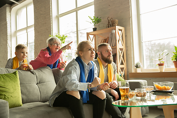 Image showing Excited family watching football, sport match at home, top view