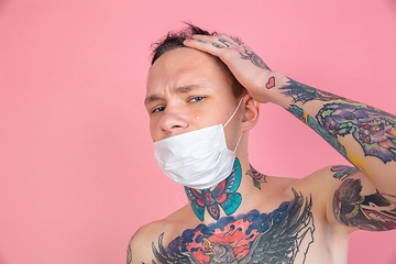 Image showing Portrait of young man with freaky appearance on pink background