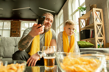 Image showing Excited family watching football, sport match at home, father and son