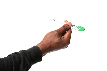 Image showing How coronavirus changed our lives. Close up of male hands holding thermometer, taking temperature on white background