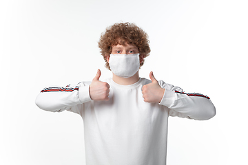 Image showing How coronavirus changed our lives. Young man wearing face mask to stop spreading on white background