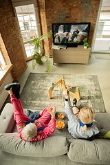 Image showing Excited family watching football, sport match at home, grandma, mother and son