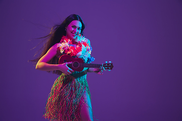 Image showing Fabulous Cinco de Mayo female dancer on purple studio background in neon light