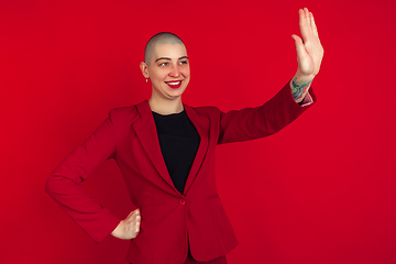 Image showing Portrait of young caucasian bald woman on red background