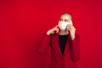 Image showing Portrait of young caucasian bald woman on red background