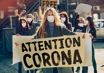 Image showing Young people in face masks protesting of stop coronavirus pandemic on the street