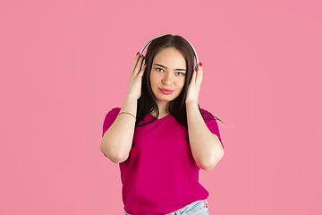 Image showing Monochrome portrait of young caucasian brunette woman on pink background