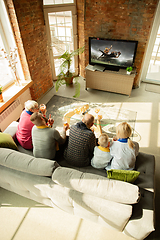 Image showing Excited family watching american football, sport match at home
