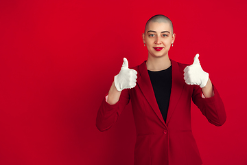 Image showing Portrait of young caucasian bald woman on red background