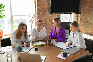 Image showing Business young caucasian woman in modern office with team