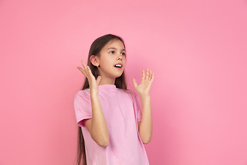 Image showing Caucasian little girl portrait isolated on pink studio background, emotions concept