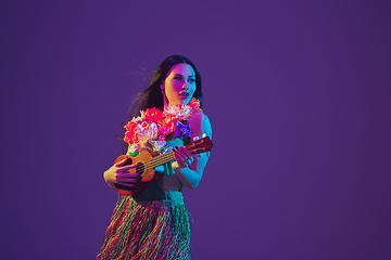 Image showing Fabulous Cinco de Mayo female dancer on purple studio background in neon light