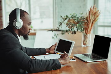 Image showing Businessman or student working from home while being isolated or keep quarantine \'cause of coronavirus COVID-19