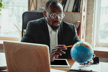 Image showing Businessman or student working from home while being isolated or keep quarantine \'cause of coronavirus COVID-19