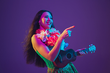 Image showing Fabulous Cinco de Mayo female dancer on purple studio background in neon light