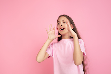 Image showing Caucasian little girl portrait isolated on pink studio background, emotions concept