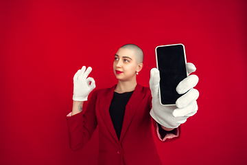 Image showing Portrait of young caucasian bald woman on red background