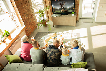 Image showing Excited family watching american football, sport match at home