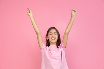 Image showing Caucasian little girl portrait isolated on pink studio background, emotions concept