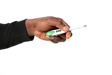 Image showing How coronavirus changed our lives. Close up of male hands holding thermometer, taking temperature on white background