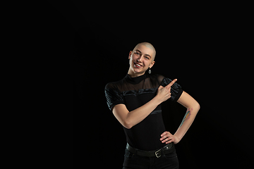 Image showing Monochrome portrait of young caucasian bald woman on black background