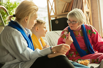 Image showing Excited family watching football, sport match at home, grandma, mother and son