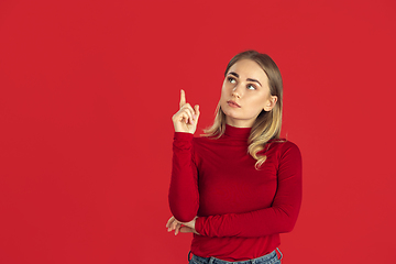 Image showing Monochrome portrait of young caucasian blonde woman on red background