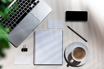 Image showing Creative and cozy workplace at home office, inspirational mock up with plant shadows on table surface