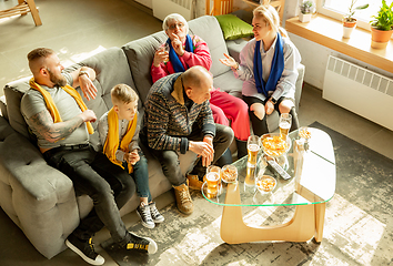 Image showing Excited family watching football, sport match at home, top view