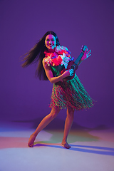 Image showing Fabulous Cinco de Mayo female dancer on purple studio background in neon light