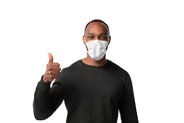 Image showing How coronavirus changed our lives. Young man wearing face mask to stop spreading on white background